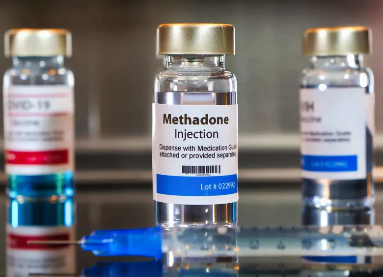 Several vials of Methadone Injection with an attached syringe, for medical use.