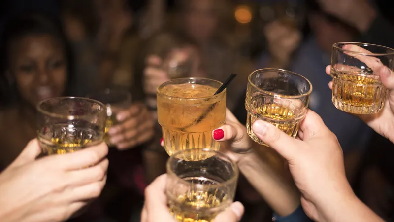 Primary Liver Cancer Group of people raising glasses of alcohol, symbolizing heavy drinking as a risk factor for primary liver cancer