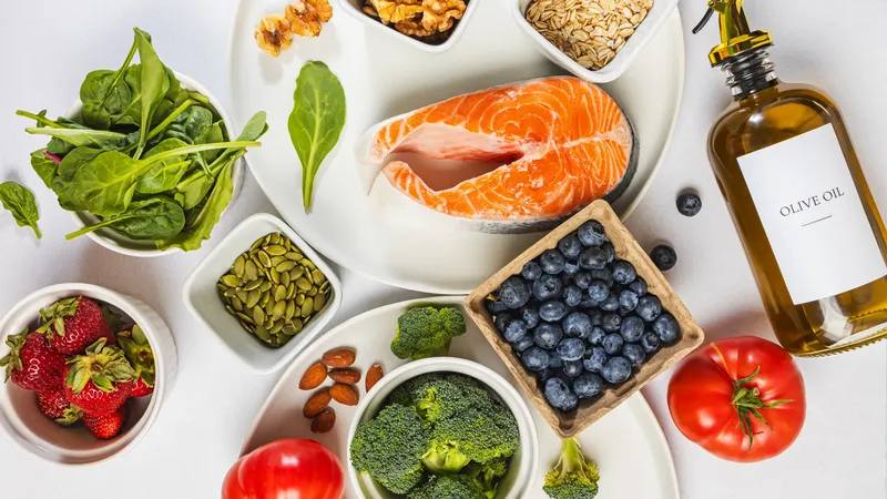 Selection of antioxidant-rich foods including salmon, berries, spinach, nuts and olive oil