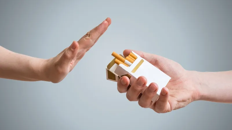 Hand refusing a pack of cigarettes to prevent leukemia risk