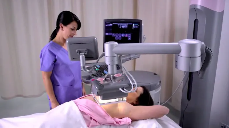 Healthcare professional performing a regular breast screening examination on a patient using advanced imaging equipment