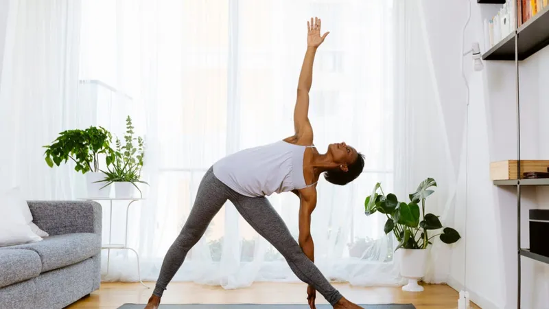 Woman practicing yoga at home to reduce the risk of lymphoma