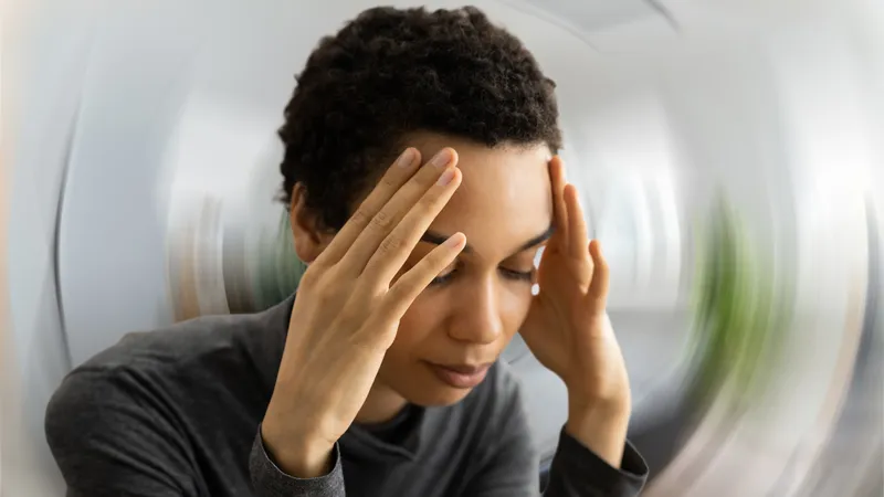 Person experiencing dizziness, a common symptom of meningioma