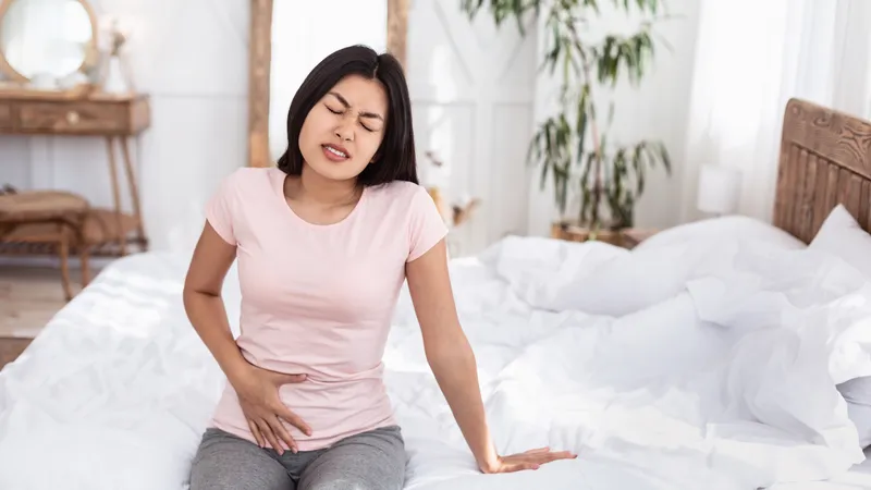 Woman experiencing pelvic pain, a common symptom of choriocarcinoma (placental cancer)