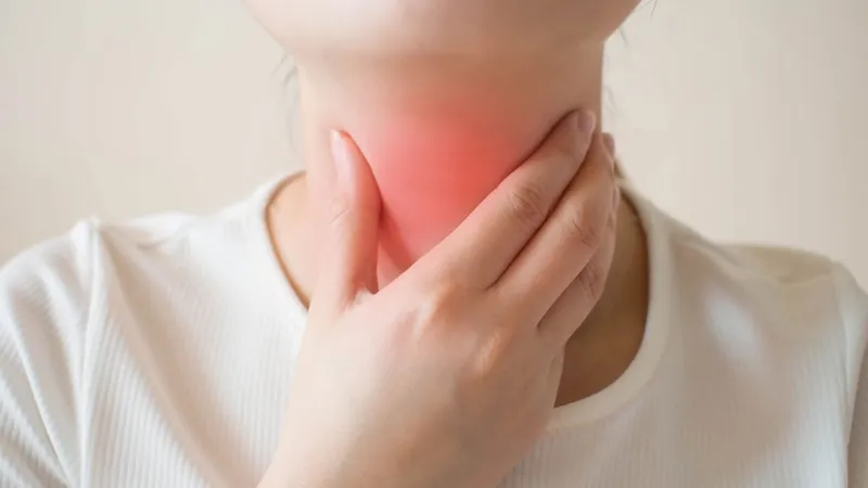 Pharyngeal Cancer Person experiencing difficulty swallowing, a common symptom of pharyngeal cancer.