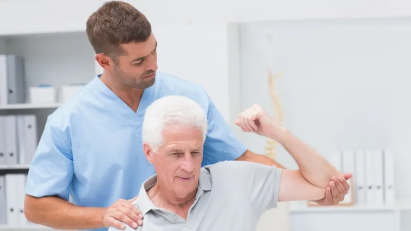 Connective Tissue Cancer Elderly man receiving physiotherapy for functional recovery after surgery for soft tissue cancer