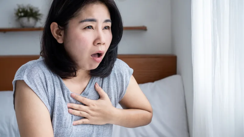 Woman experiencing breathing difficulties, indicating possible thymoma symptoms