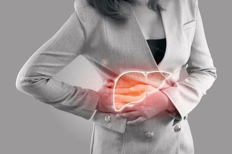 Primary Liver Cancer Woman holding her upper right abdomen, highlighting liver area, indicating pain caused by primary liver cancer