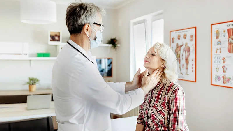 Doctor examining patient’s lymph nodes, as autoimmune disorders may increase the risk of Non-Hodgkin Lymphoma
