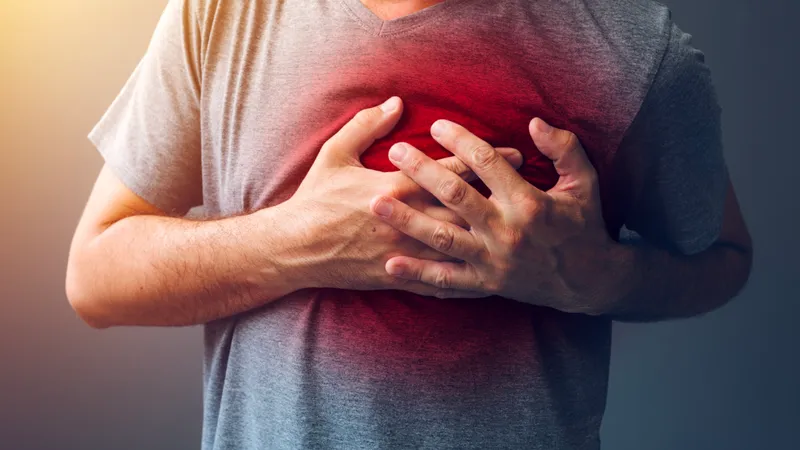 Man holding chest due to chest pain caused by blood clotting disorder