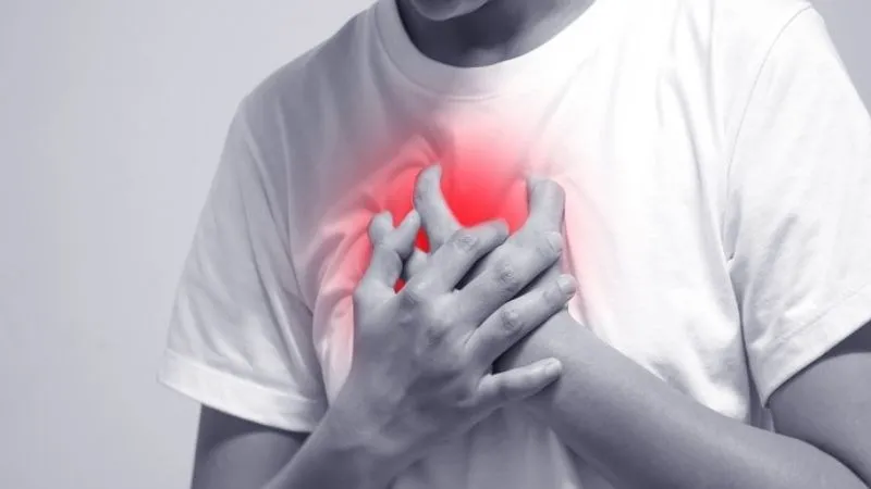 Thrombocytosis Person clutching chest in pain, indicating possible heart or blood clot complication from thrombocytosis
