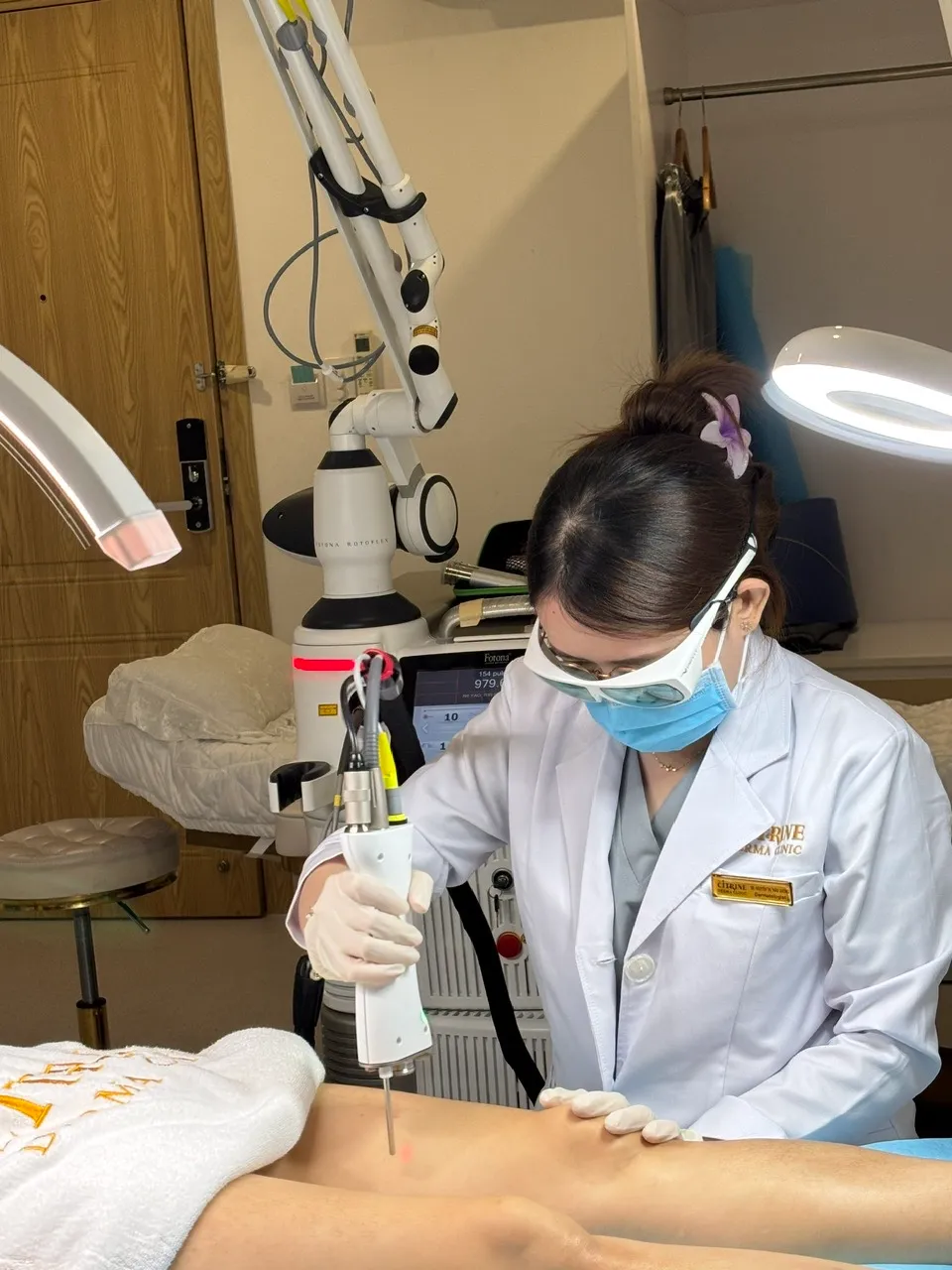 Dermatologist performing He-Ne laser therapy for atopic dermatitis treatment