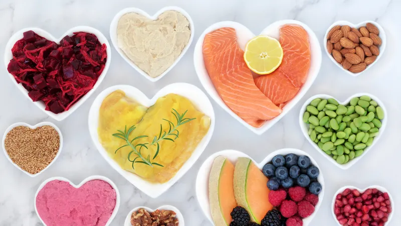 Heart Palpitations Heart-healthy foods including salmon, fruits, and nuts arranged in heart-shaped bowls