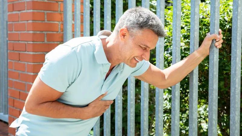 Man experiencing chest pain, a possible complication of hemolytic anemia leading to heart failure.