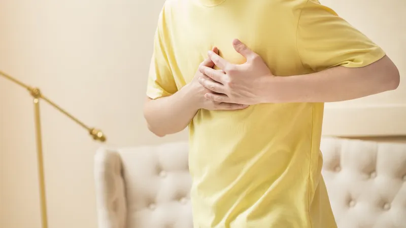 Person experiencing chest pain due to possible heart arrhythmia, which can be hereditary