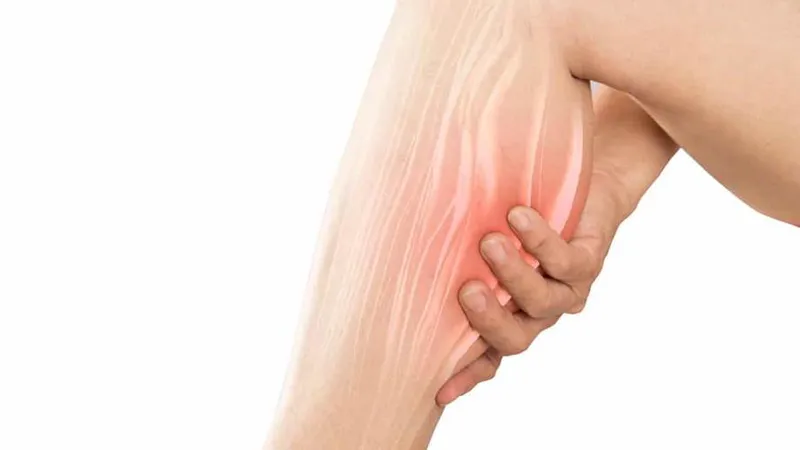 Person experiencing pain and swelling in the leg, a common symptom of liposarcoma