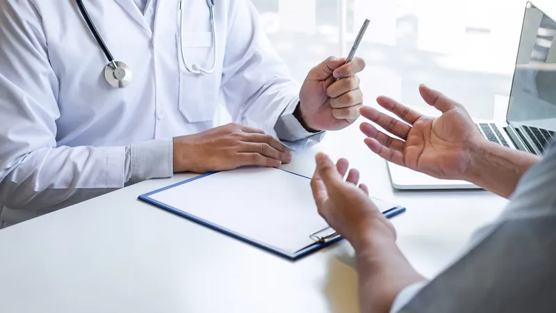 A doctor consulting with a patient during a medical appointment, discussing treatment options.